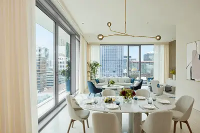 Luxurious modern living room with panoramic city views and elegant dining area.