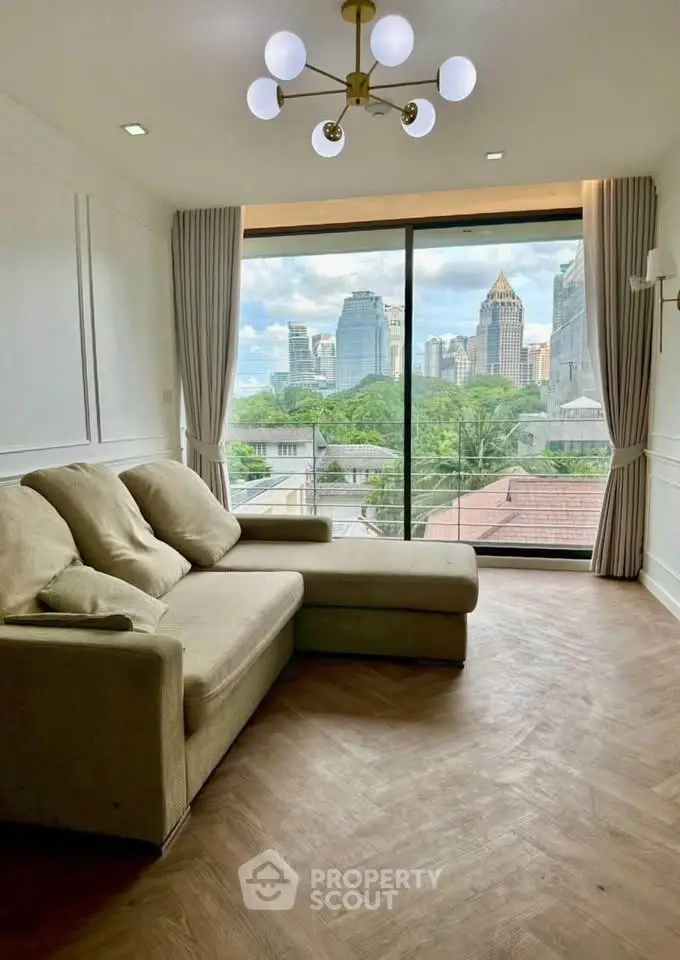 Spacious living room with city view, featuring modern lighting and cozy seating.