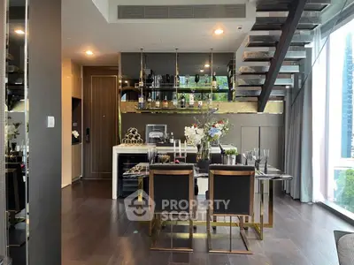 Luxurious modern dining area with elegant staircase and floor-to-ceiling windows in a high-end apartment.