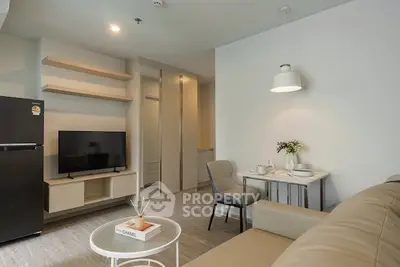 Modern living room with sleek furniture and open layout, featuring a cozy dining area and stylish decor.