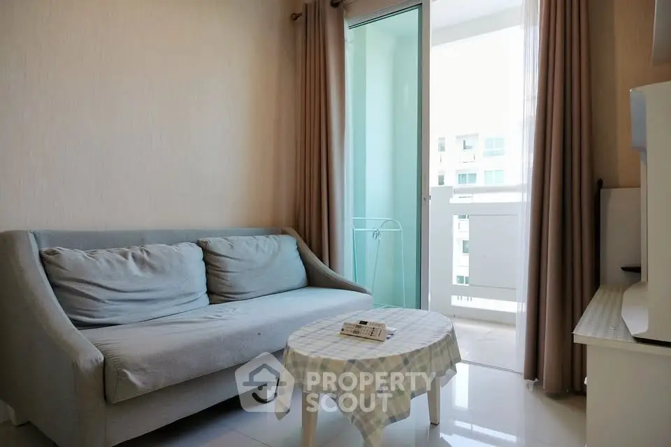 Cozy living room with balcony access in modern apartment