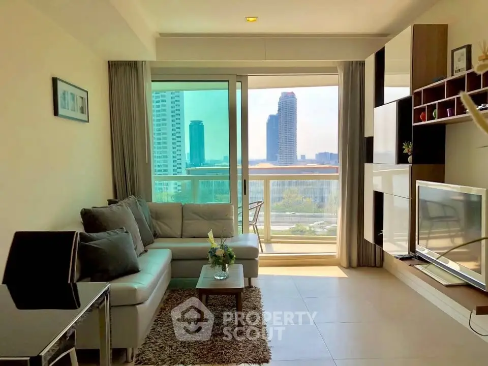 Modern living room with city view, stylish furniture, and natural light in a high-rise apartment.