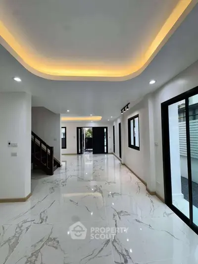 Spacious modern living room with elegant lighting and marble flooring