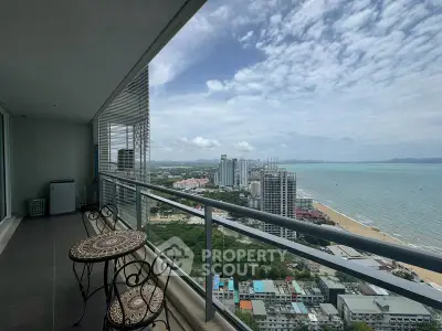 Stunning high-rise balcony with breathtaking ocean view and elegant outdoor seating.