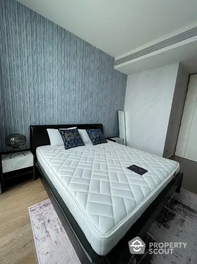 Modern bedroom with stylish decor and comfortable bed in luxury apartment.