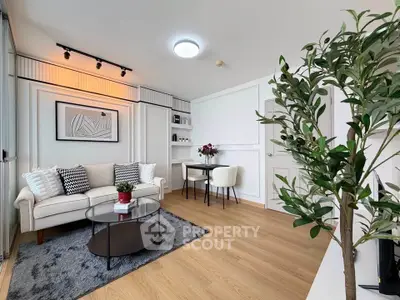 Modern living room with stylish decor, cozy seating, and elegant wooden flooring.