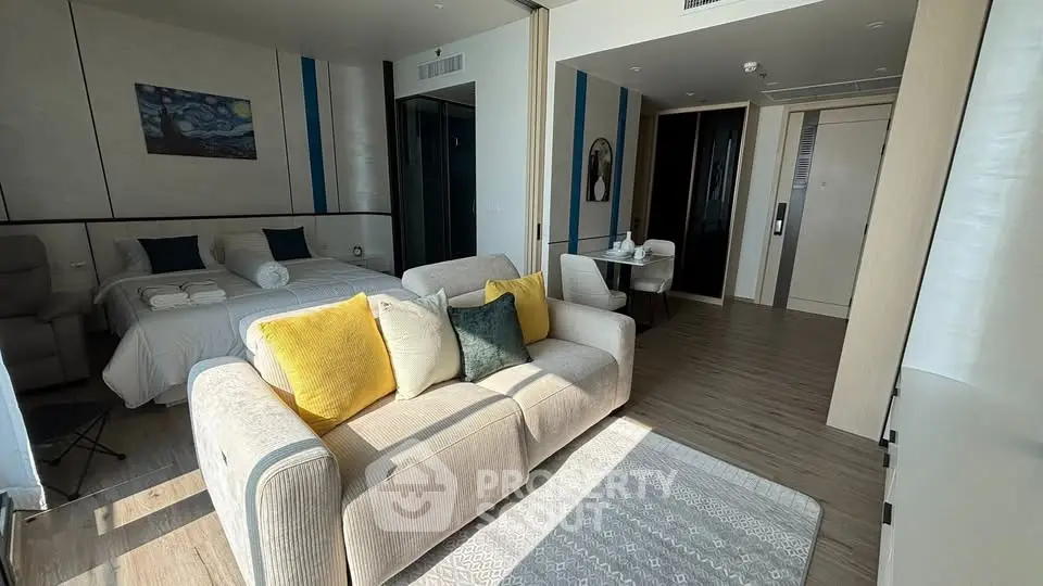 Modern studio apartment with cozy living area and stylish decor