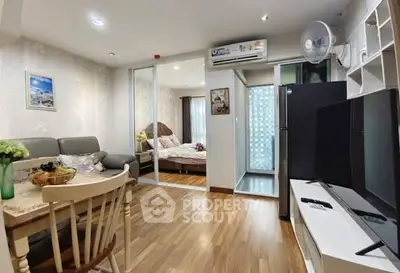 Modern apartment interior with open living and dining area, featuring wooden flooring and cozy decor.