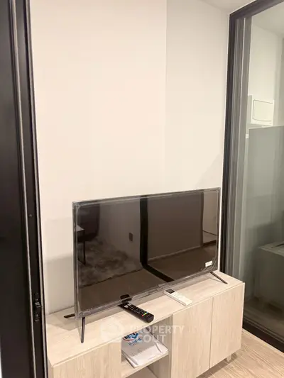 Modern living room with sleek TV setup and stylish wooden cabinet