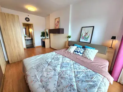 Spacious bedroom with modern decor and cozy bedding in a stylish apartment.