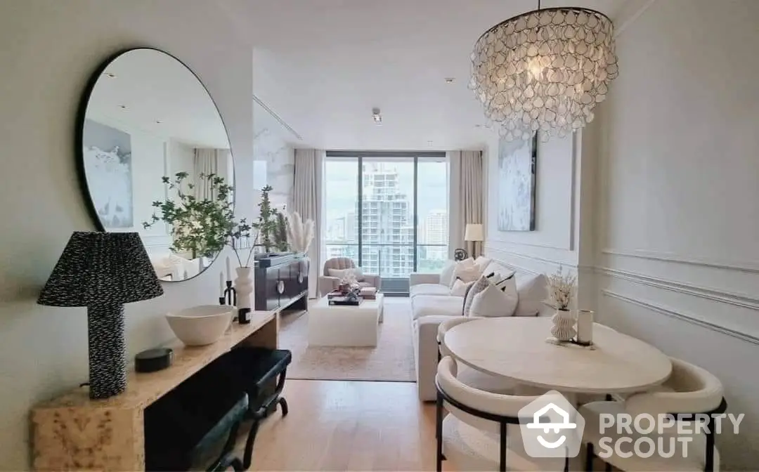 Elegant living room with chic decor, large mirror, and abundant natural light from floor-to-ceiling windows leading to a spacious balcony.