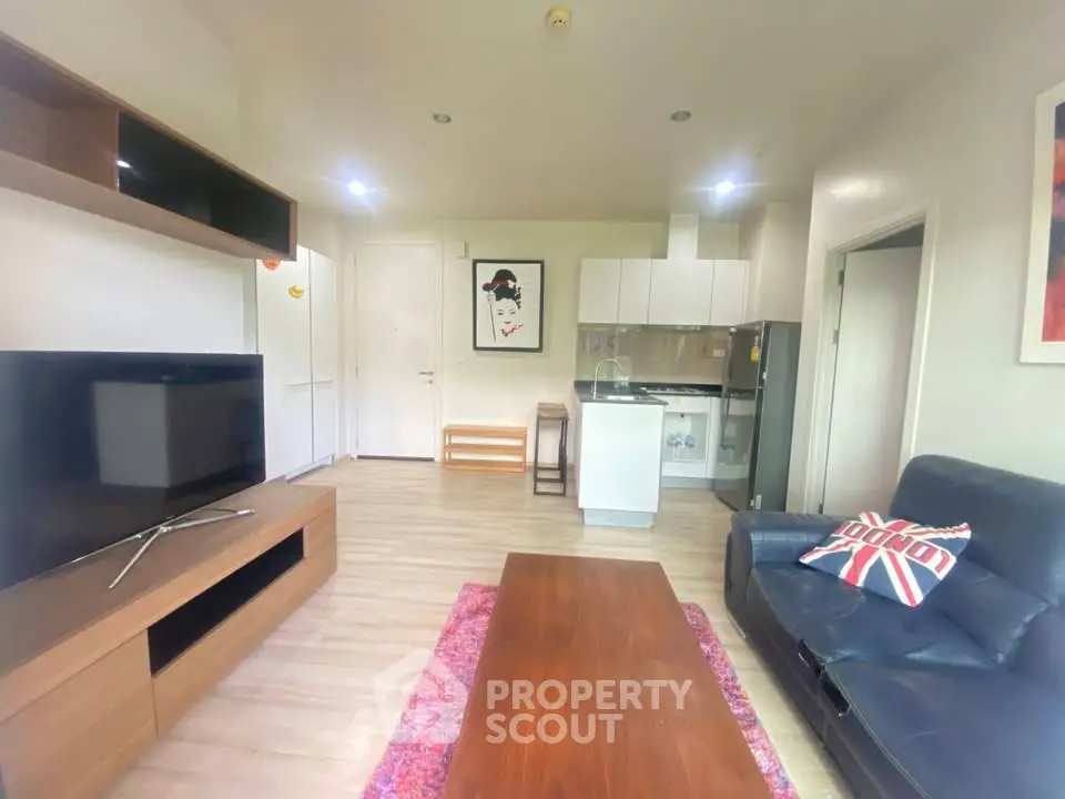Modern living room with sleek furniture and open kitchen layout