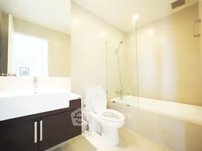 Modern bathroom with sleek fixtures and glass shower partition