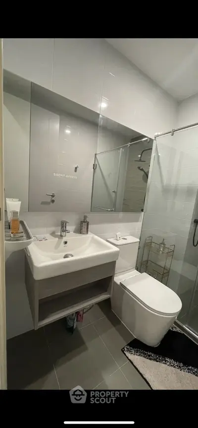 Modern bathroom with sleek fixtures and glass shower enclosure