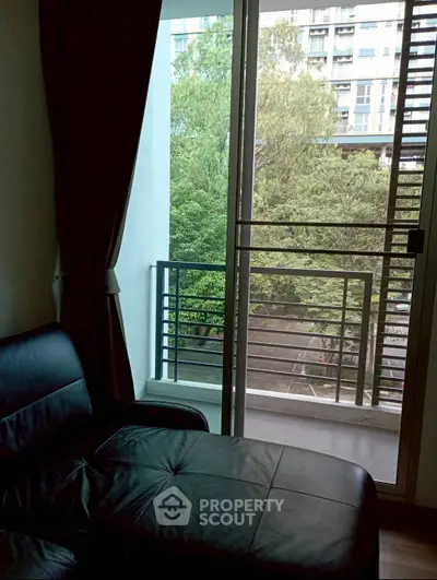 Cozy living room with balcony view in modern apartment