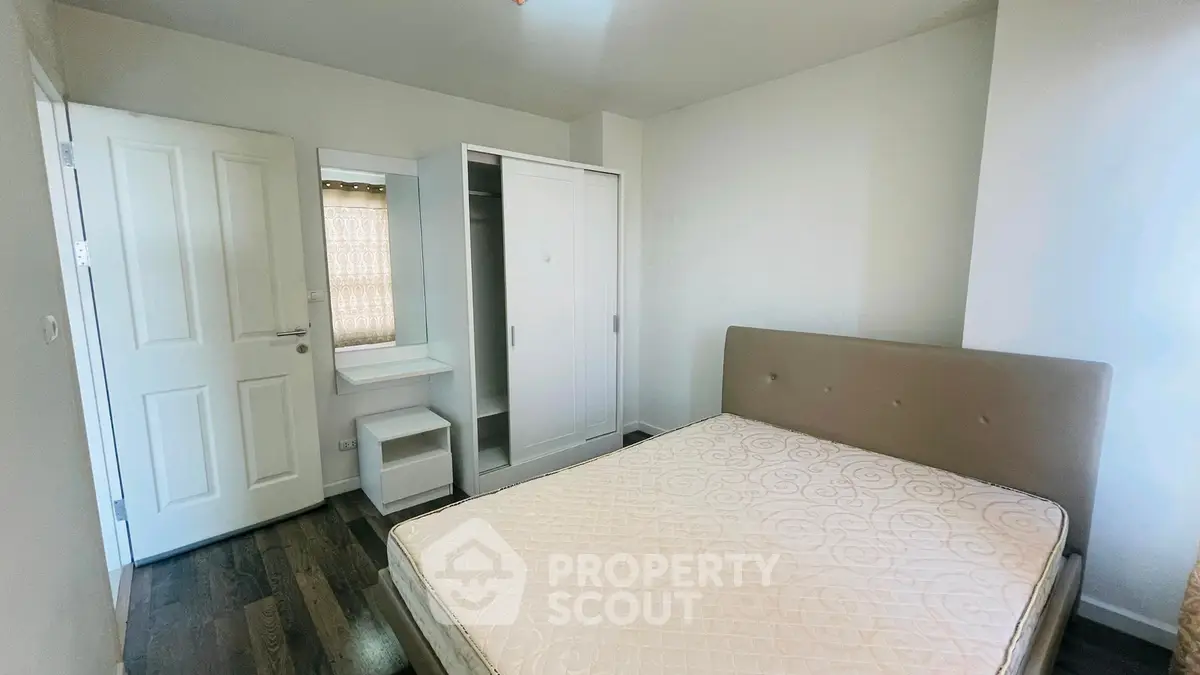 Cozy bedroom with modern furniture and ample storage space, perfect for comfortable living.