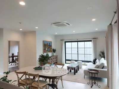 Spacious living room with modern decor and large windows for natural light.