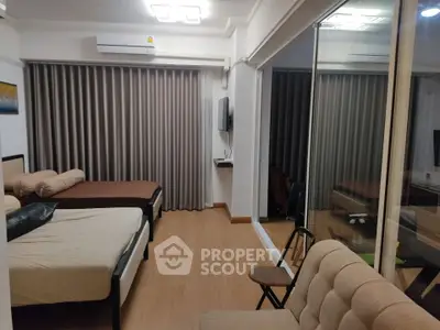 Spacious bedroom with modern decor and large window view