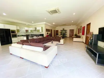 Spacious open-plan living room with modern kitchen and elegant decor