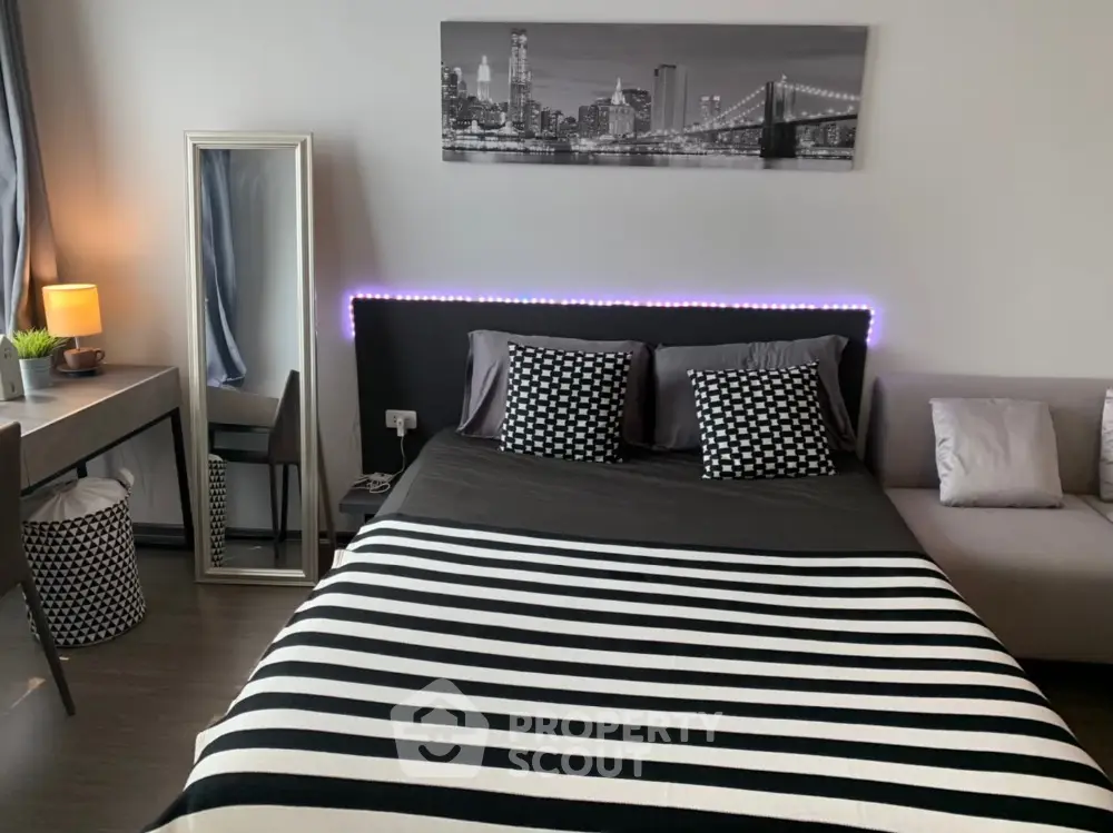 Modern bedroom with stylish decor and cityscape artwork