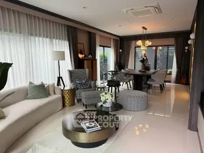Luxurious modern living room with elegant decor and large windows for natural light.