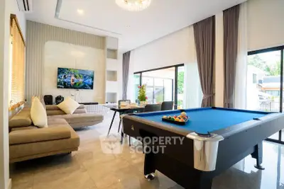 Luxurious living room with pool table and modern decor, perfect for entertainment.