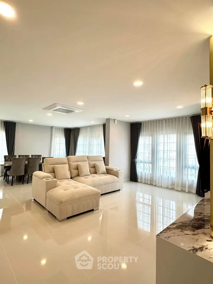 Spacious modern living room with elegant dining area and natural light