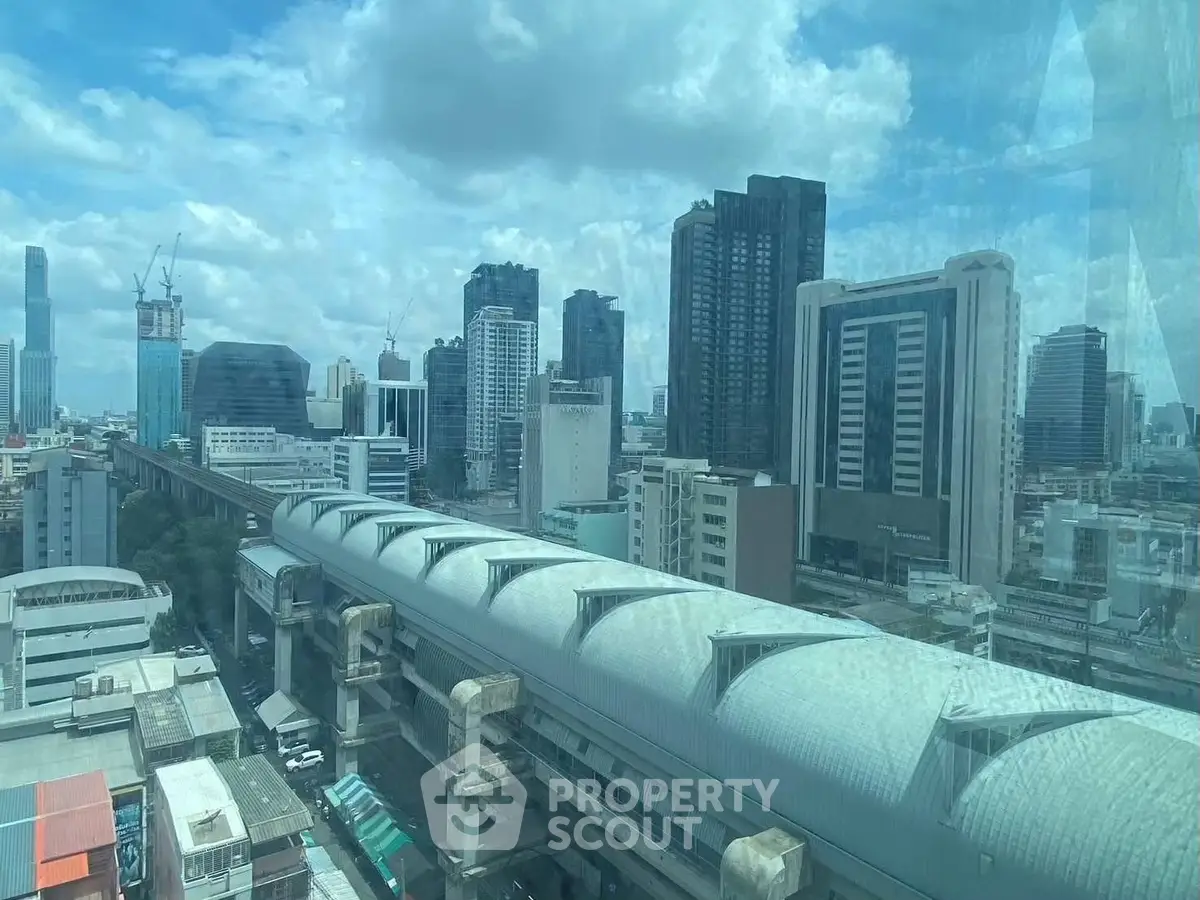 Stunning cityscape view showcasing modern skyscrapers and urban architecture under a vibrant blue sky.