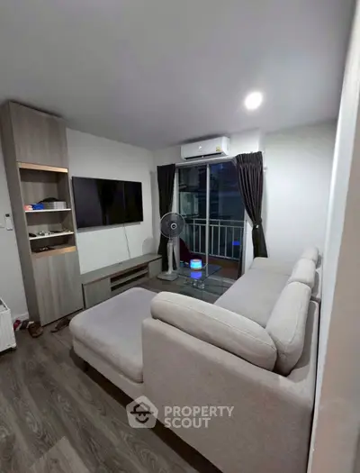 Modern living room with sleek furniture and balcony view