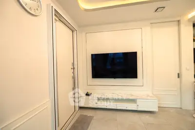 Modern living room with wall-mounted TV and sleek marble console