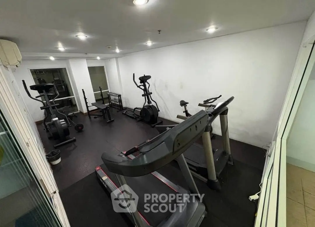 Modern gym with state-of-the-art fitness equipment in a residential building.