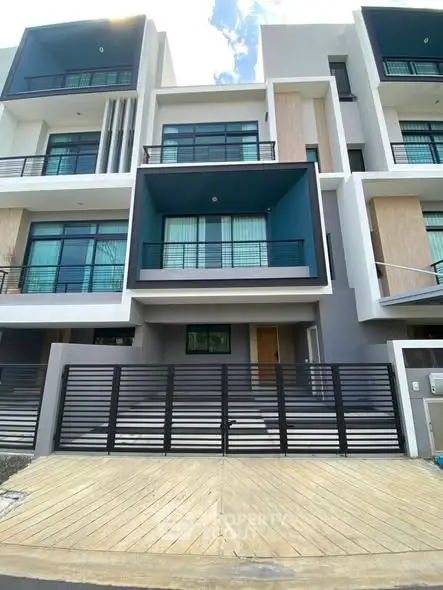 Modern multi-story townhouse with sleek design and spacious balconies in a desirable neighborhood.