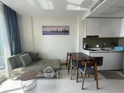 Modern living room with sleek kitchen and stylish furniture in a bright apartment.