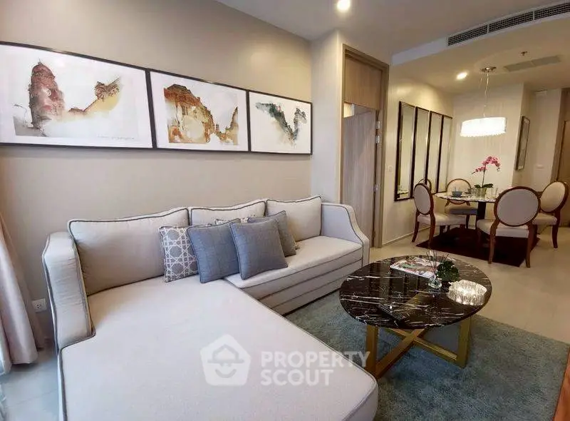 Elegant living room with modern decor and dining area in luxury apartment