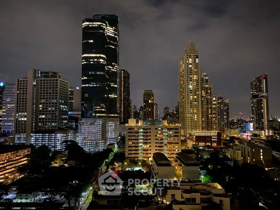 Stunning city skyline view with illuminated skyscrapers at night, showcasing urban living.