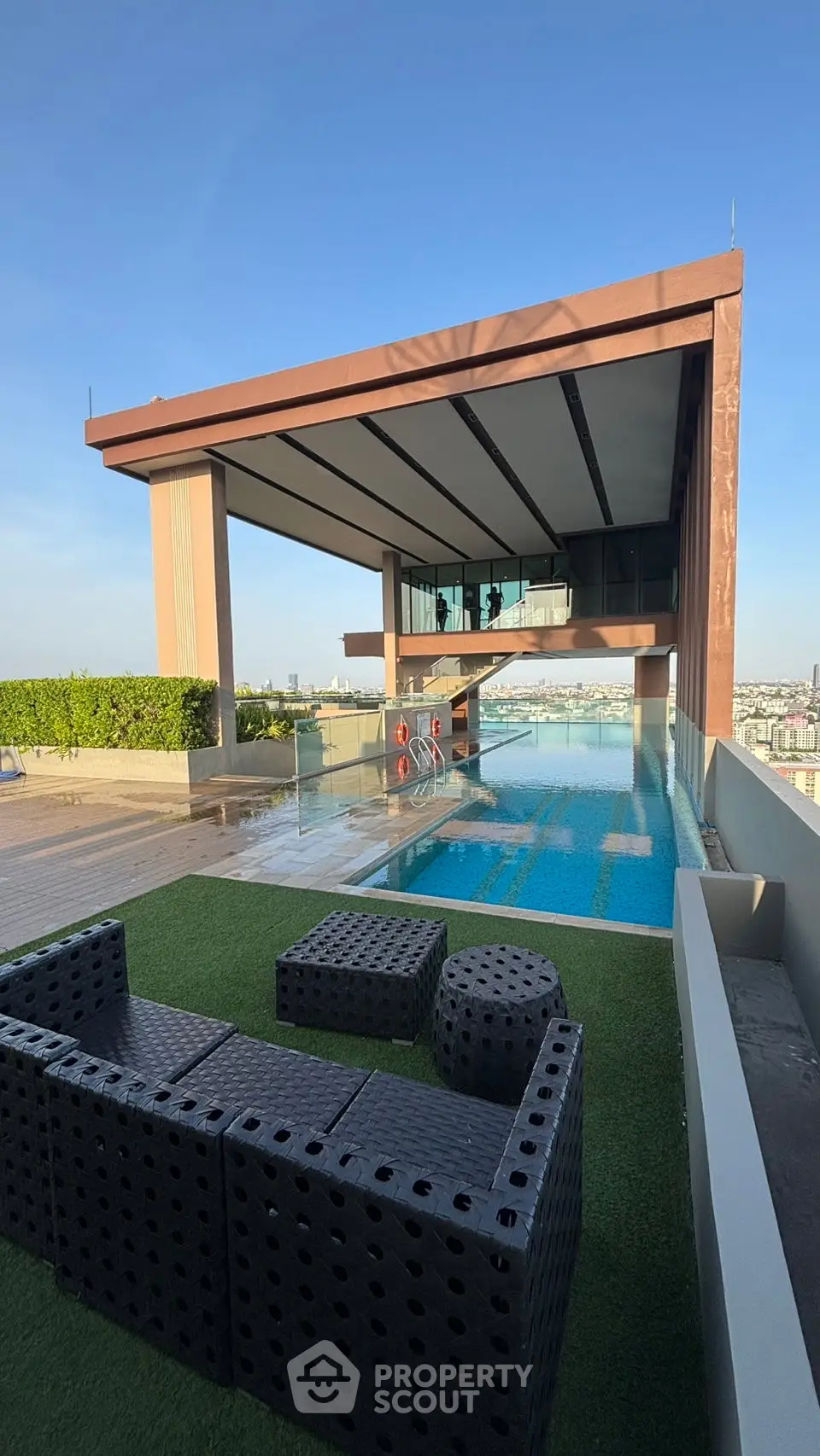 Luxurious rooftop pool with stunning city views and modern seating area.