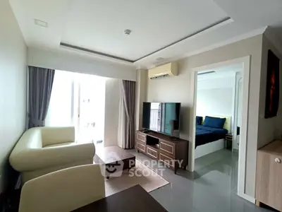 Modern living room with elegant furniture and open view to a cozy bedroom, perfect for urban living.