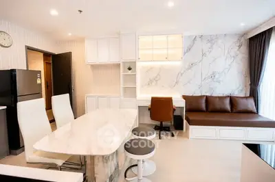 Modern open-layout living room with marble accents and stylish furniture