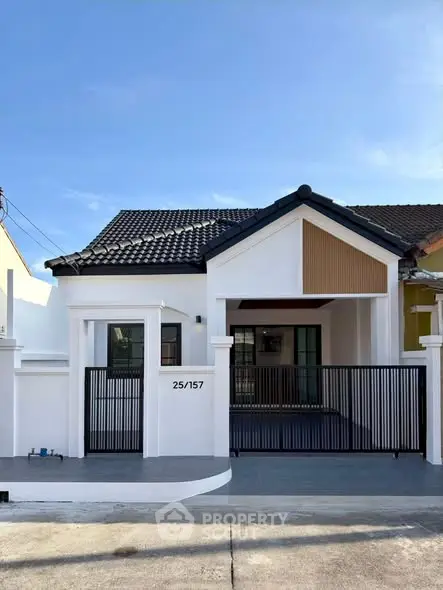 Charming single-story house with modern facade and gated entrance