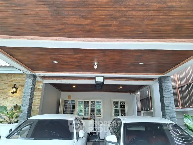 Spacious covered parking area with modern design and two cars