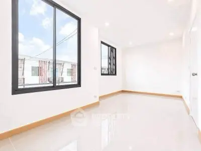 Bright and spacious empty room with large windows and glossy tiled floor, perfect for customization.
