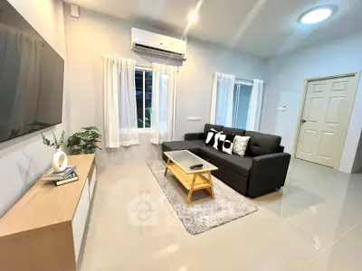 Modern living room with sleek furniture and air conditioning, perfect for comfortable living.