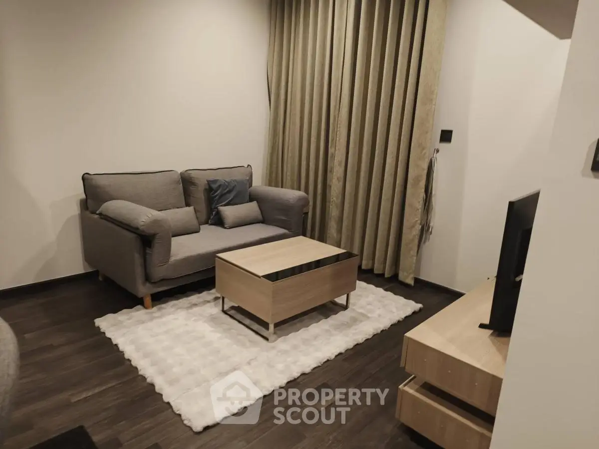 Cozy living room with modern sofa and TV setup, perfect for relaxation.