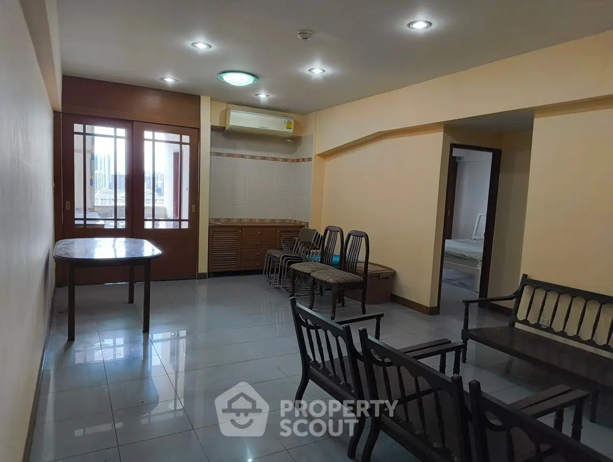 Spacious living room with ample seating and natural light, perfect for family gatherings.