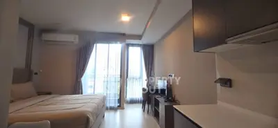Modern studio apartment with cozy bedroom and open kitchen layout.