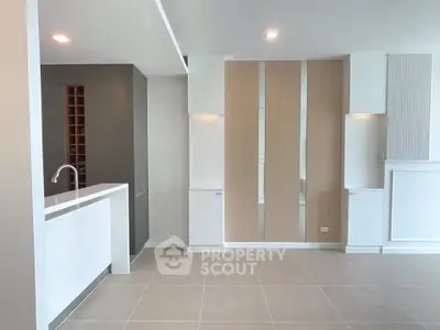 Modern open-plan living area with sleek kitchen design and neutral tones.