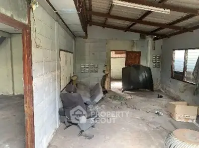 Spacious unfinished garage with potential for renovation and customization.