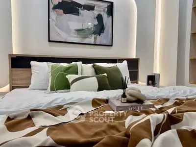 Stylish bedroom with modern decor and cozy bedding, perfect for relaxation.