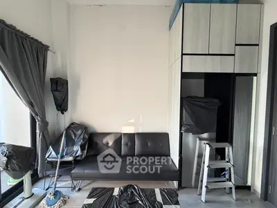 Modern living room with sleek black sofa and stylish storage cabinets