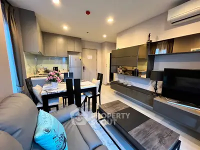 Modern living room with sleek furniture and open kitchen layout in a stylish apartment.